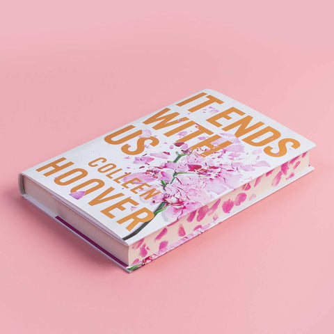 It Ends with Us hardback showing exquisitely sprayed edges angled against a pink background