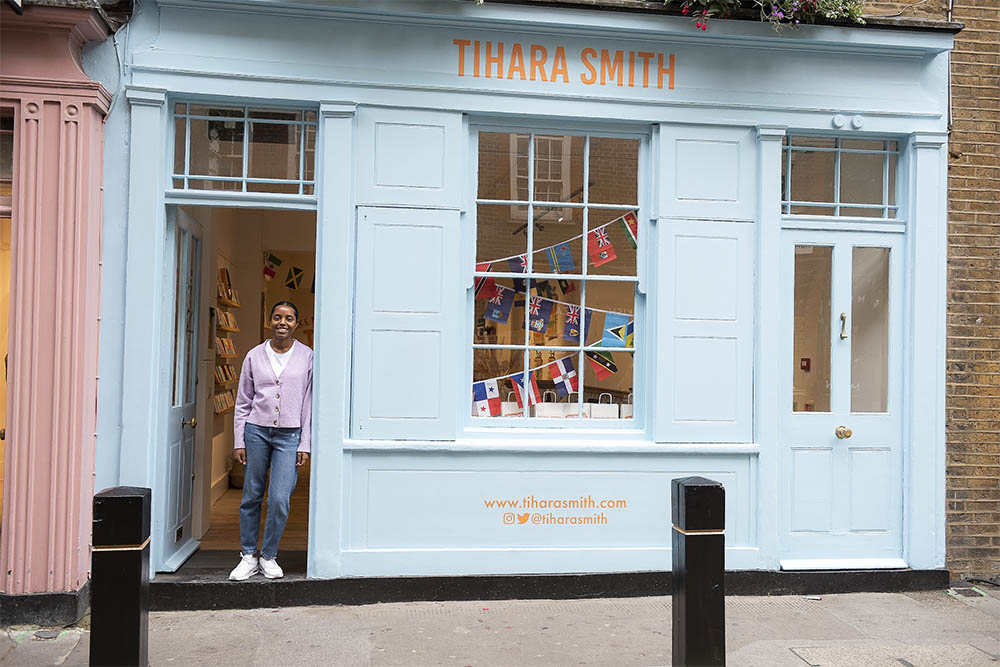 Image of Tihara Smith in the door way of a bright sky blue shop