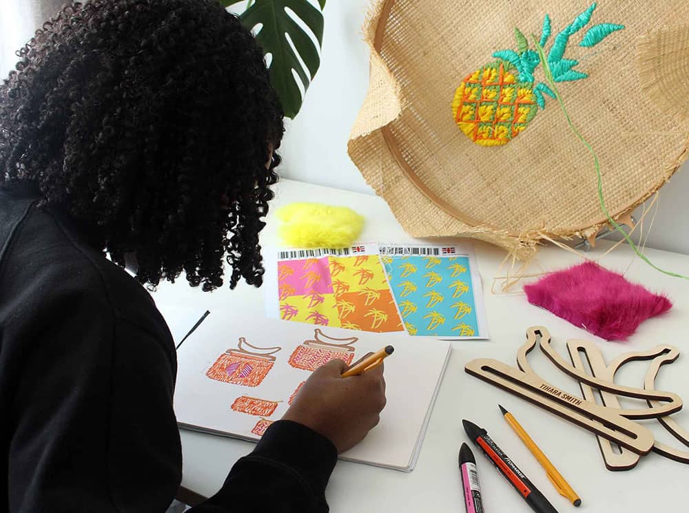 Tihara Smith drawing her bag designs