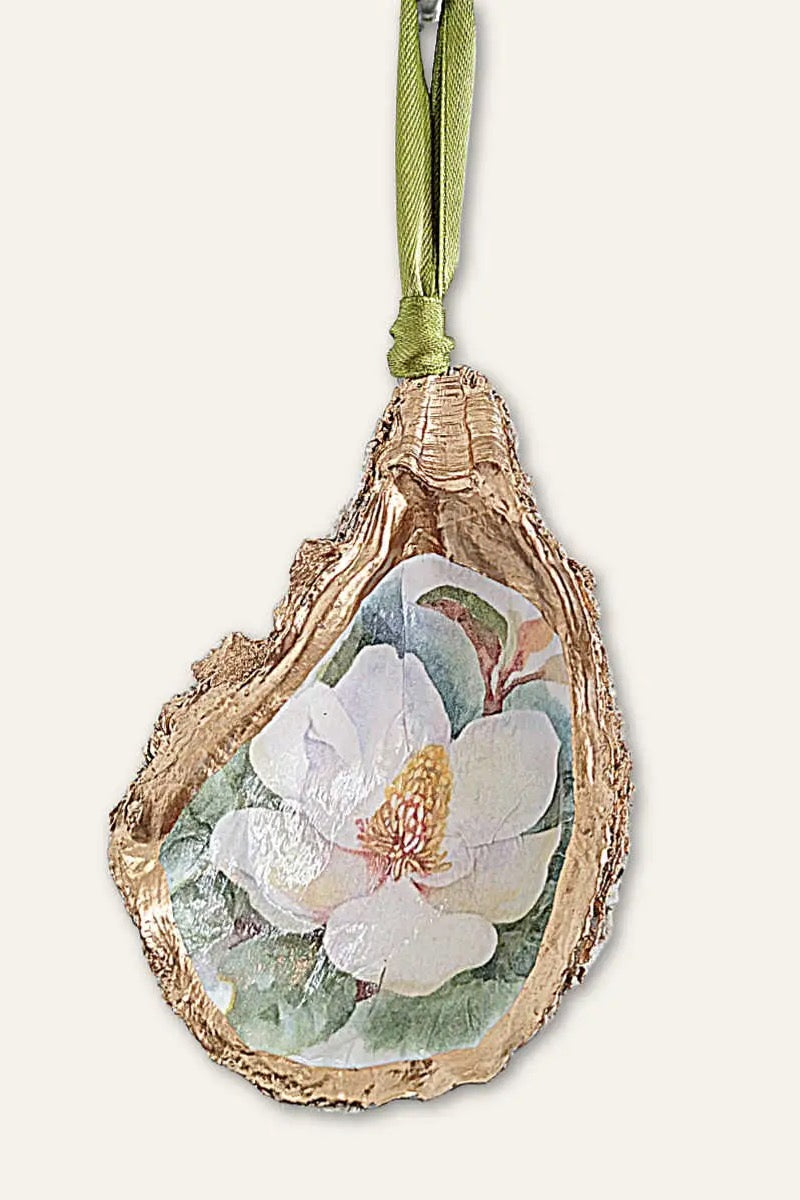 Handcrafted in our very own New Orleans, this beautiful oyster shell ornament features a watercolor Magnolia flower and is the perfect holiday decoration for any and all New Orleans lovers! Meticulously sealed and detailed with golden gilders enamel, then adorned with a metallic ribbon and packaged with an Algiers Oyster Company hang tag. Not to mention ~ they make just about the cutest gift we can imagine!