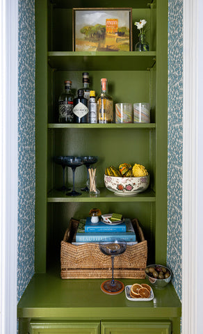 Elliston House's Dover pattern in House Blue covering the walls of a bar nook painted in Sherwin Williams dark green.