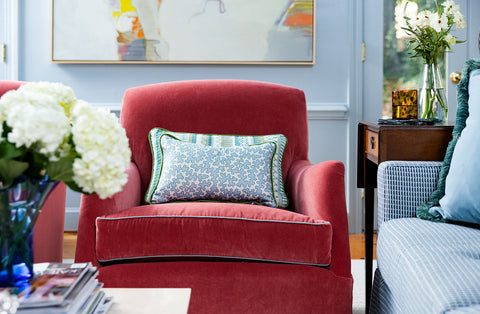 Living room featuring a rouge velvet chair by Greenhouse Fabrics and Elliston House's Dover House Blue throw pillow.