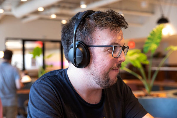A man at the office wearing his Bose 700 Noise Cancelling Headphones
