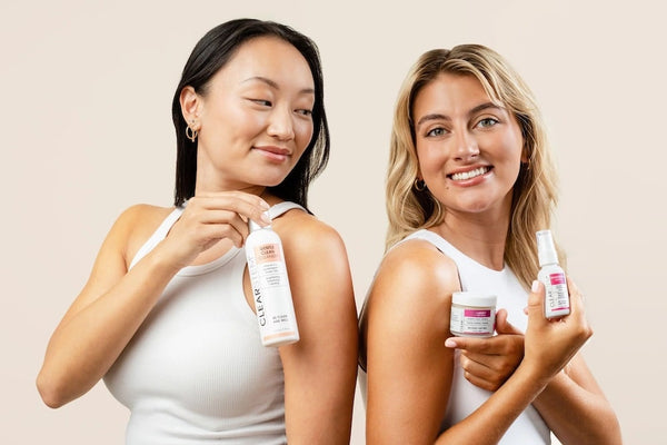 A photo of two models holding up Clearstem skincare products