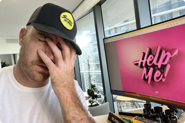 Sunday Scaries CEO, Mike Sill, is stressed while working at his computer with the background on this screen reading "Help Me!"