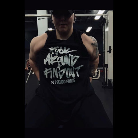 Abbey Fangman flexing shoulders at the gym in FAFO t shirt by Pseudo Force Gym Cltohes