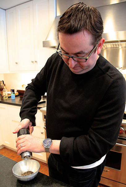 Chef Todd Stein grinding the Reluctant Tellicherry Peppercorns.
