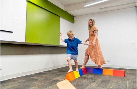 Mum and Son, walking together on a balance beam