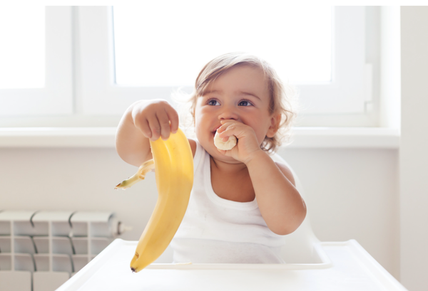 Baby eating banana