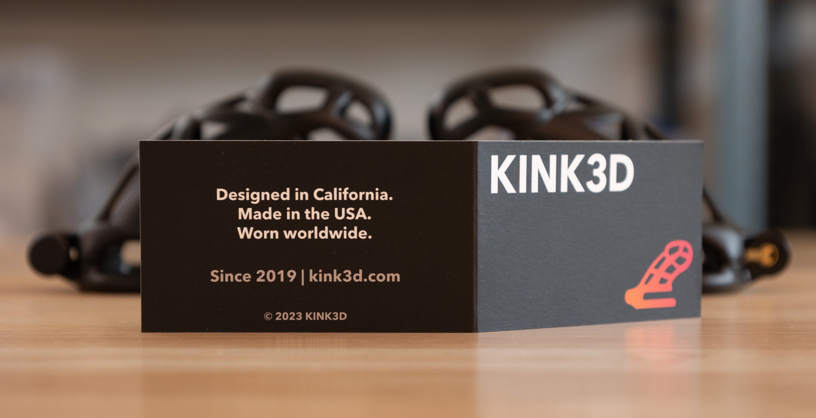 KINK3D Cobra product insert card with chastity cages in background