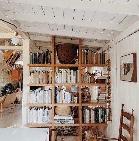 Open shelving book shelf serving as a wooden room divider