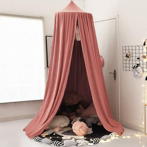 Pink draping canopy for indoor reading nook with flowy fabric