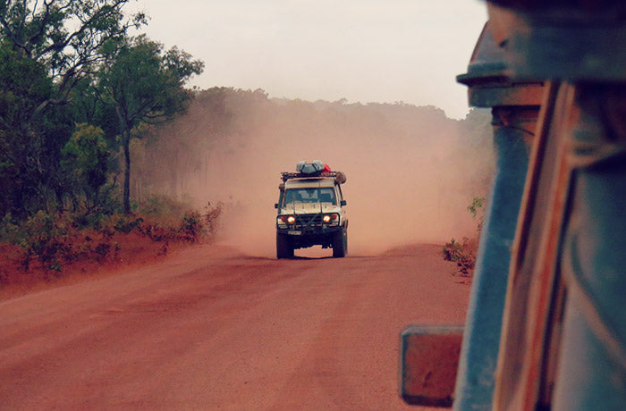 4WD driving off road on a dusty track with a GPS