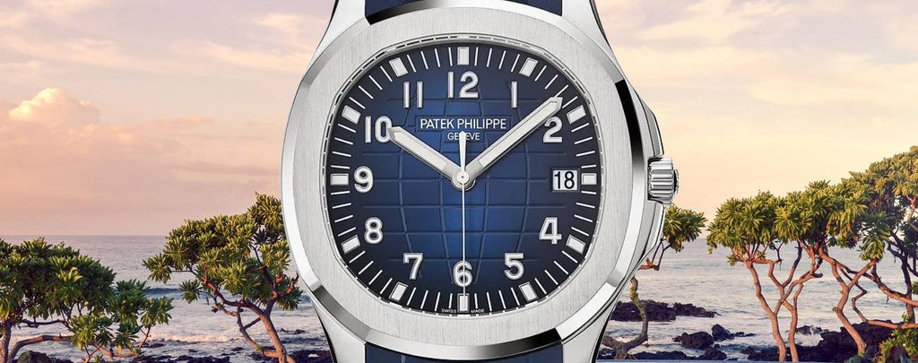 Close-up photo of a Patek Philippe Aquanaut watch in stainless steel with a blue embossed dial and a blue rubber strap