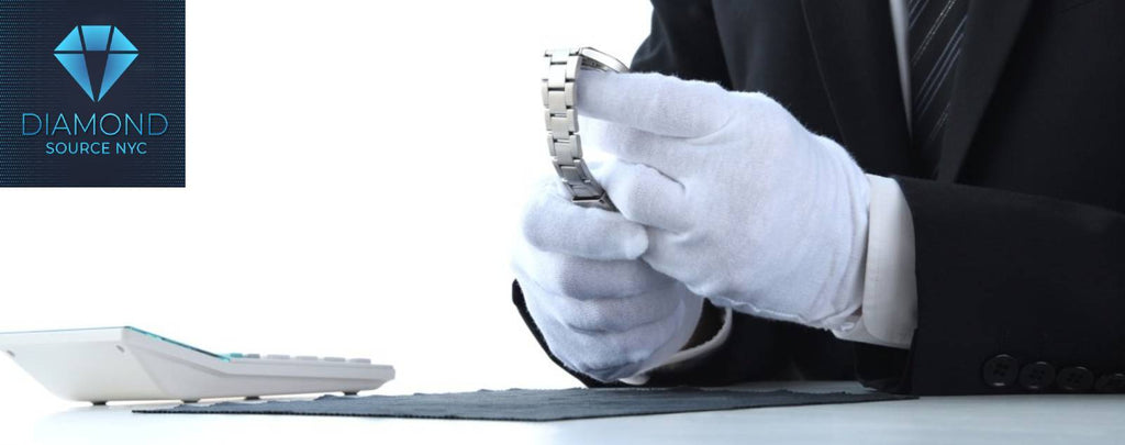 Professional watch appraiser examining a luxury watch under magnification