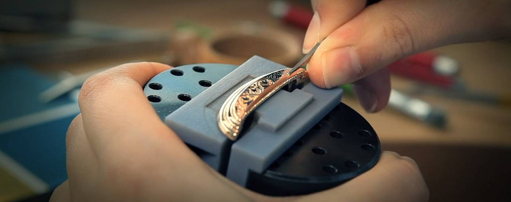 A close-up image of a watchmaker meticulously working on a watch, polishing a tiny component
