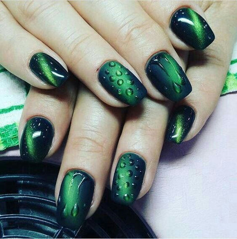 Dark green nail tips with water droplets
