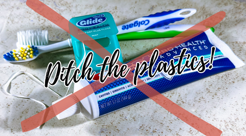 plastic toothbrush, toothpaste and floss containers sitting on a counter with a red x and the words ditch the plastics over it