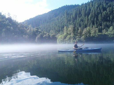 Artist Jess Alice kayaking on a still, flat water foggy lake in Northern California. Adventure, outdoor, kayak and exploring flatwater 