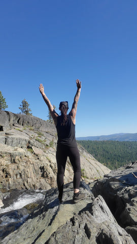 Artist Jess Alice standing over Fraizer Falls outside of Graeagle, California in the Gold Lake Basin Wildnerness Area in Plumas County, CA. Attending 2023 Graeagle Great American Art and craft Faire.