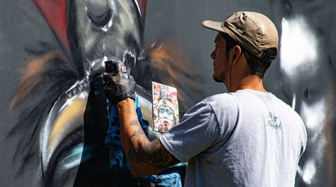 Man painting on a wall.