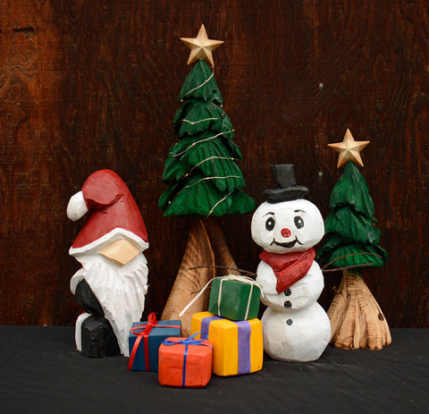 Santa, Snowman, Christmas Tree with star, twinkle lights, Presents. One-of-a-kind hand-made chainsaw-carved wood sculptures from California Cedar and painted with exterior paint for indoor or outdoor accents. Colorful and unique holiday home decor perfect for any space.