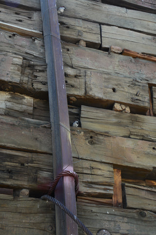 Birdy is a photograph by Artist Jess Alice from Virginia City Nevada of a small bird hidden away in the railroad ties