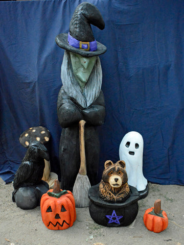 Halloween Decorations, indoor and outdoor Fall decor for home, and business. Chainsaw Carved from California Cedar. 4ft Witch holding her broom, hat tilted town, green face with warts, scary spooky horror, traditional character witch style with black witch hat, long black rode, purple accents, grey hair ghosts, pumpkins and mushrooms, pumpkins, jack-o-lantern, Bear in a cauldron makes this a festive scene that livens up any space.