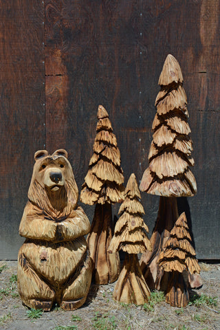 Bear and four tree chainsaw carved display. Chainsaw carved wood sculptures Artist Jess Alice Raw California cedar Handcrafted artwork Unique wooden sculptures Rustic chainsaw carvings Nature-inspired art One-of-a-kind creations Natural beauty of cedar wood Artistic craftsmanship SEO Description: Discover the exquisite world of chainsaw carved wood sculptures by renowned artist Jess Alice. Each piece is meticulously crafted from raw California cedar, showcasing the natural beauty and authenticity of the wood. With a passion for nature-inspired art, Jess Alice creates unique and one-of-a-kind sculptures that capture the essence of the subject. From majestic wildlife to intricate designs, these rustic chainsaw carvings are a true testament to the artist's exceptional talent and artistic craftsmanship. Explore this captivating collection of handcrafted artwork and bring the beauty of raw California cedar into your home or collection. Artist Jess Alice wood sculptures