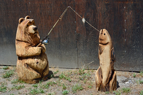 Chainsaw Carved bear and jumping fish out together in this whymsical themed display. made from california cedar, one-of-a-kind chainsaw wood carved sculptures by Artist and carver Jess Alice is perfect accent for your home or business.