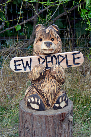 " Ew.. People" sign holding sitting Bear Chainsaw carving, wood sculptures, chainsaw art, chainsaw sculpting, wood carving, chainsaw artist, chainsaw craftsmanship, Jess Alice sculptures, female chainsaw carver, women in chainsaw carving, chainsaw carving techniques, unique wood sculptures, nature-inspired sculptures, chainsaw carving competitions, chainsaw art exhibitions, chainsaw carved animals, wood carving masterpieces, wildlife chainsaw sculptures, chainsaw carving demonstrations, chainsaw sculpture workshops, chainsaw art commissions, abstract wood sculptures, chainsaw carved tree stumps, chainsaw carving tools, sustainable wood art, chainsaw carving gallery, chainsaw sculpture festivals, chainsaw carved furniture, chainsaw carving process. "Ew.. Peoe
