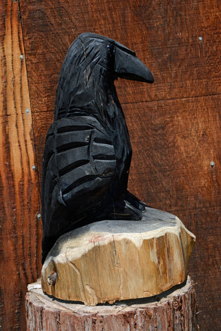 Chainsaw carven raven crow from california cedar. wood sculpture by artist jess alice one-of-a-kind handmade wood carving of a perched raven sitting on a log. perfect accent decor for your home, yard, garden or business.