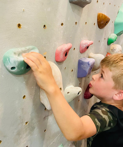 kid climbing holds