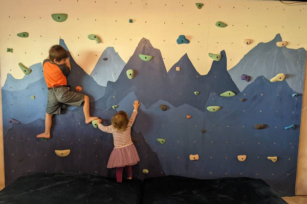kids climbing on a climbing wall