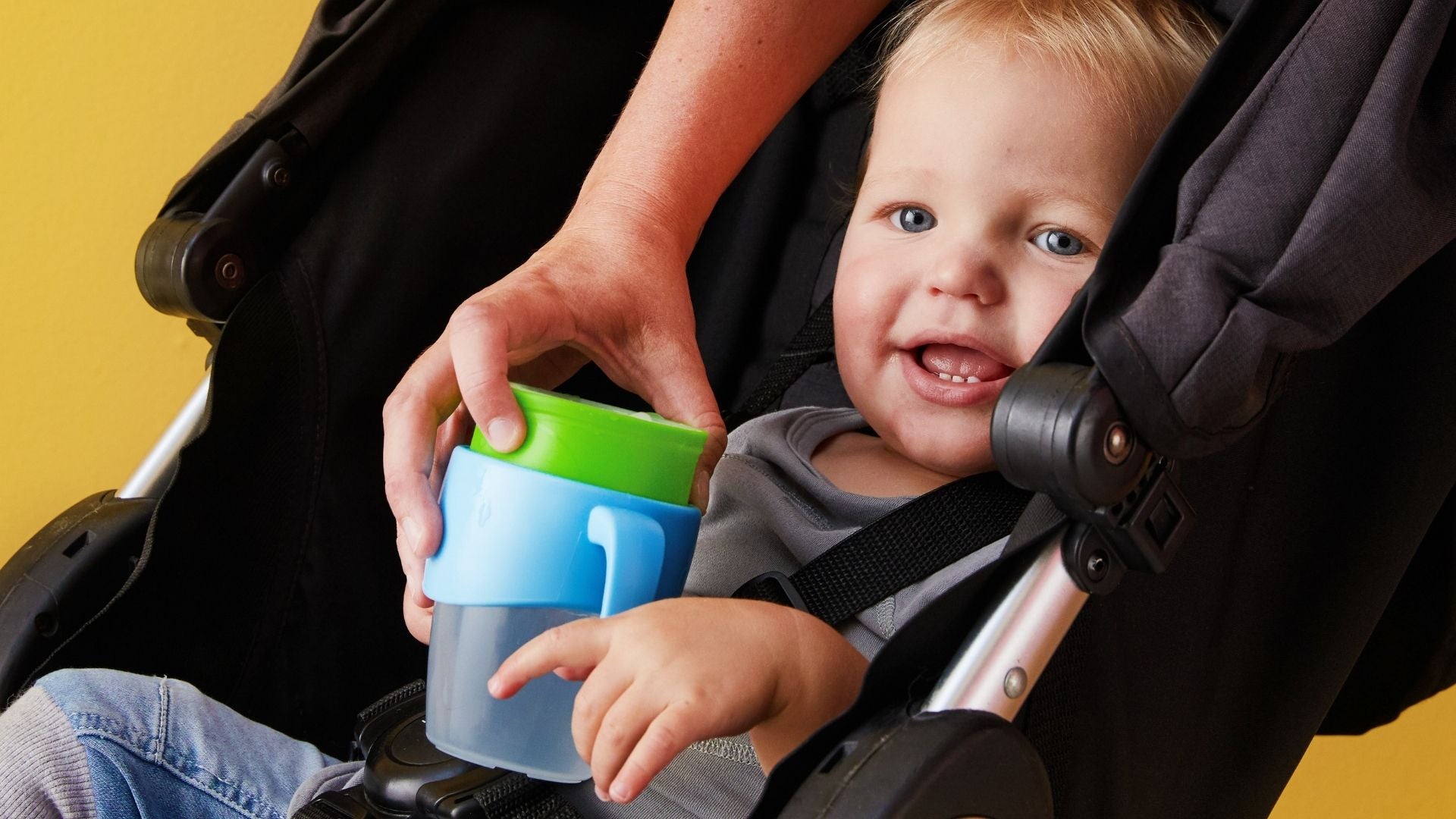 Kid in a pram with 360 cup