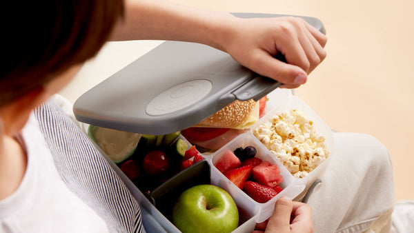 kid open b.box lunchbox filled with healthy food