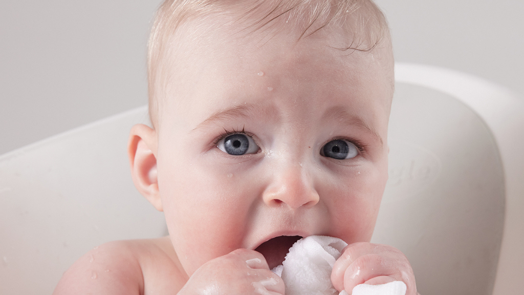 baby alone in bath before co-bathing with parent