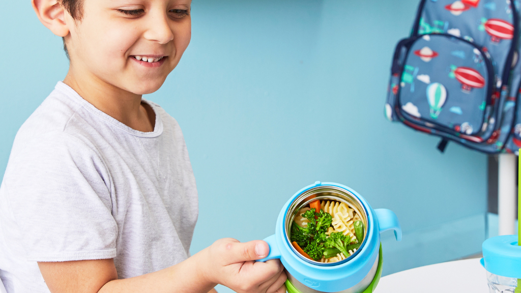 child with b.box for kids insulated food jar with pasta leftovers