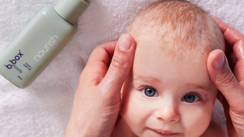 baby using b.box body nourish oil for a baby massage