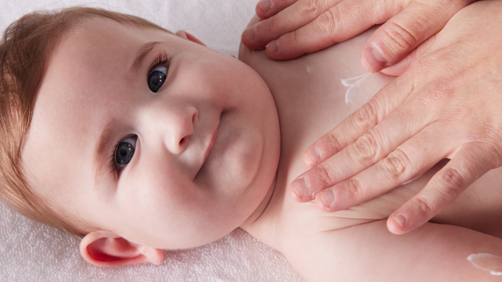 parent using pressure points in baby massage to bond