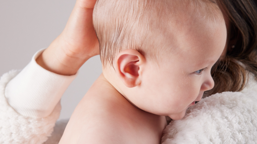 baby with sensitive skin being held by their parent