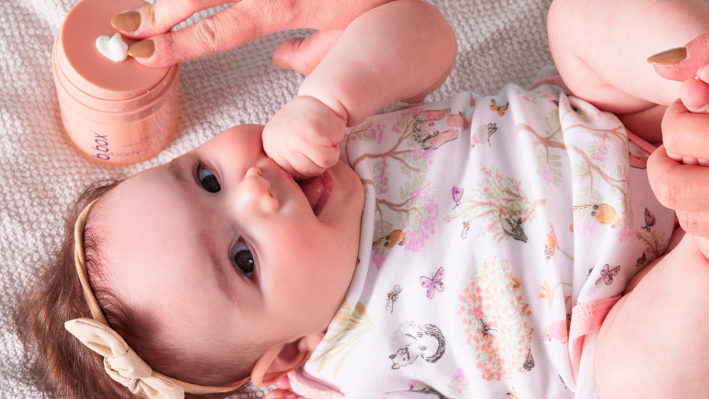 baby using b.box body protect for skin care layering