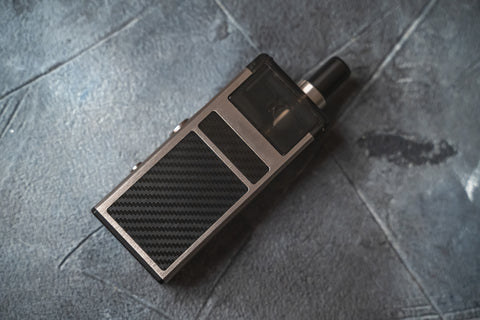 Pod Mod Vape with black and metallic colours standing in horizontal position.