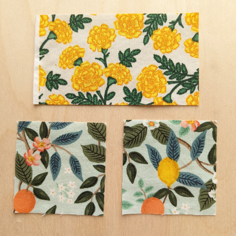 three pieces of floral fabric cut for flying geese blocks