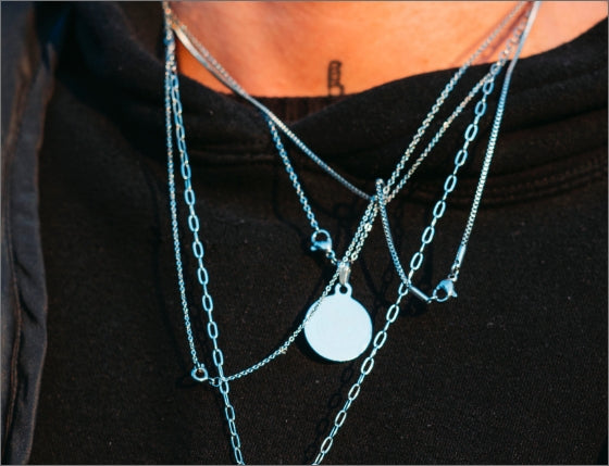 Layering necklaces on black shirt