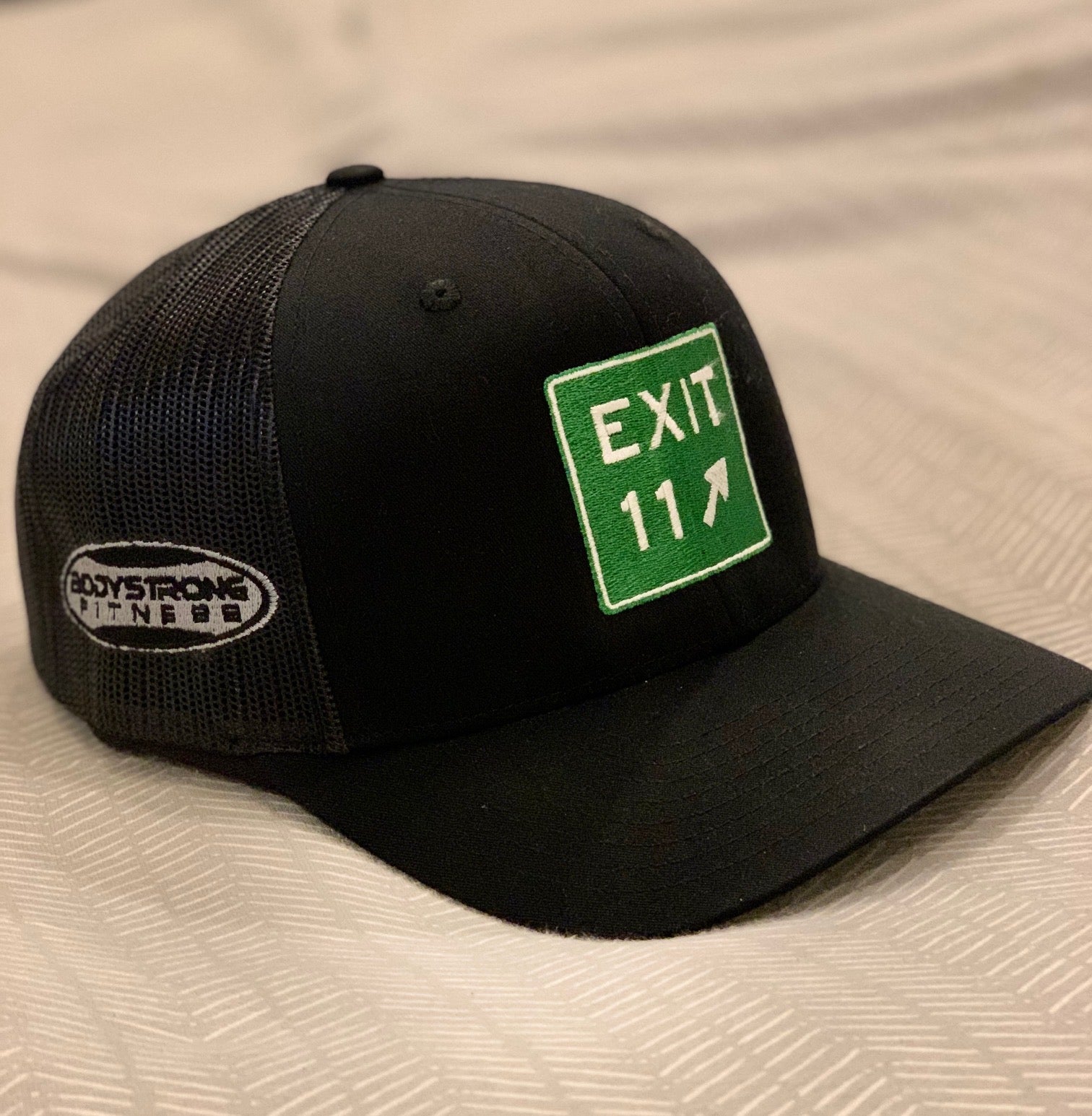 Black Richardson hat with the EXIT 11 sign on the fron and Bodystrong logo on the side