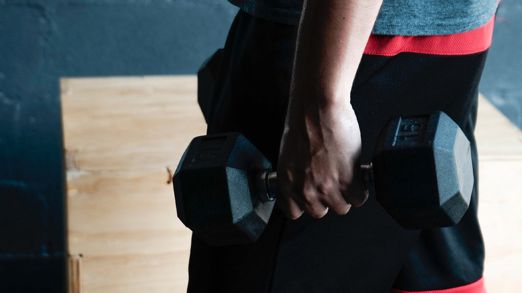 A person holding a dumbbell.