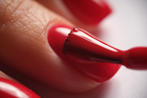 painting nail with red colour