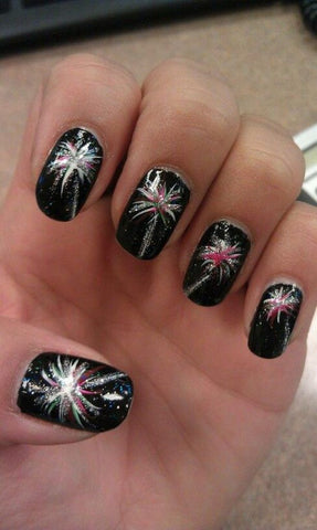 A dark background with bright starbursts and glitter will make for a stunning manicure.