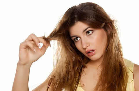 lady is worried after seeing her frizzy hairs